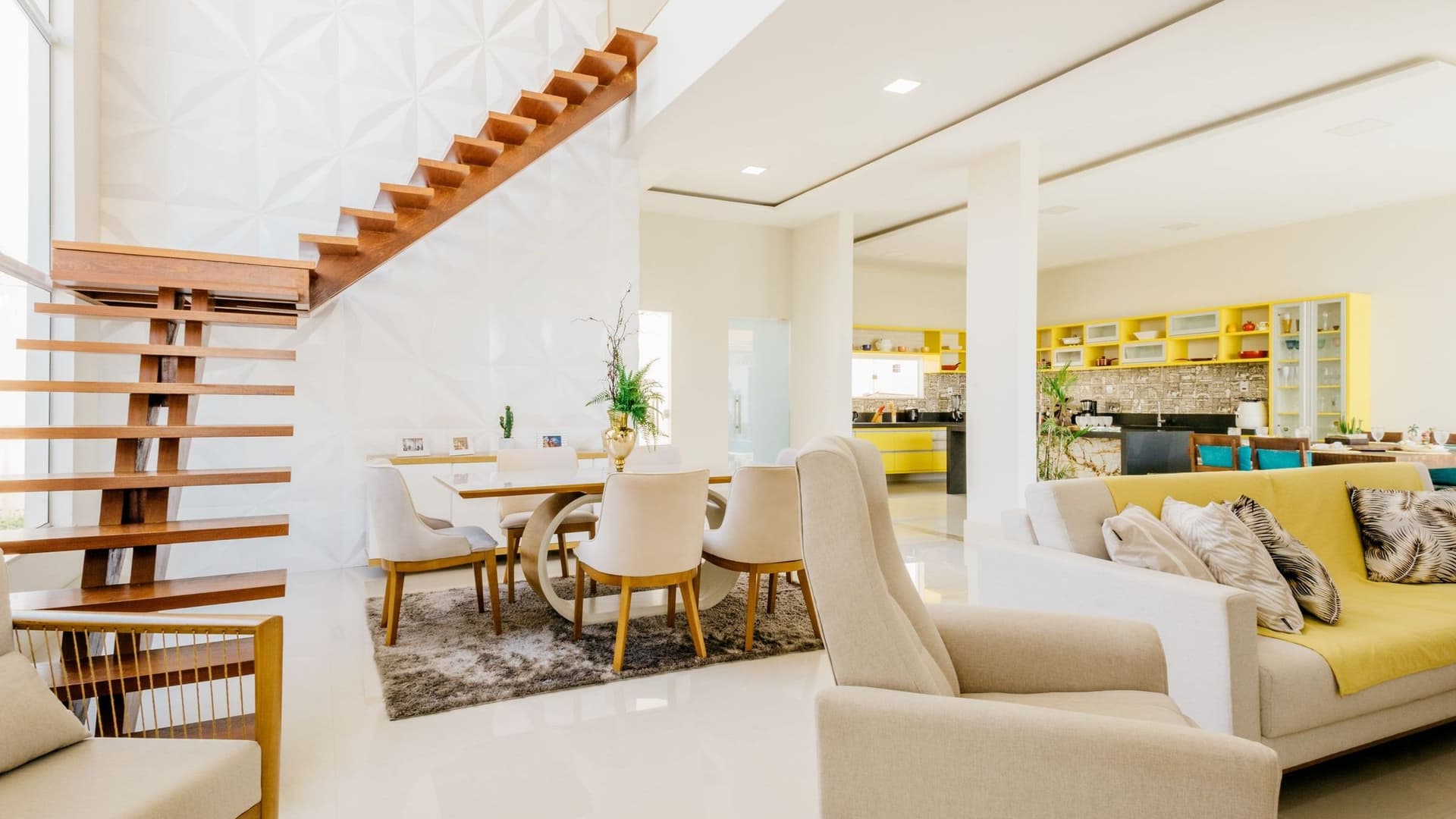 Two professional cleaners vacuuming and mopping a modern living room