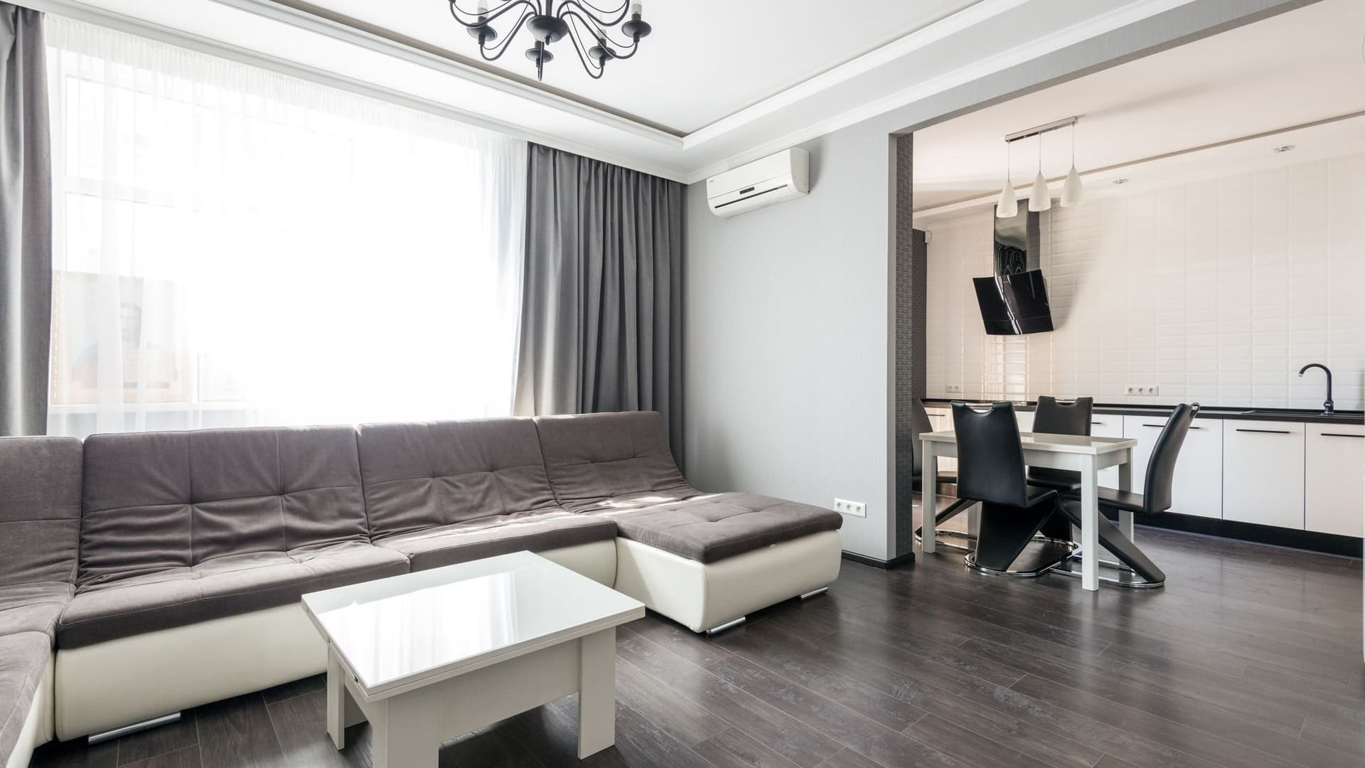 Professional cleaning crew with vacuums and mops in a modern home